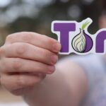 person holding logo of the onion router