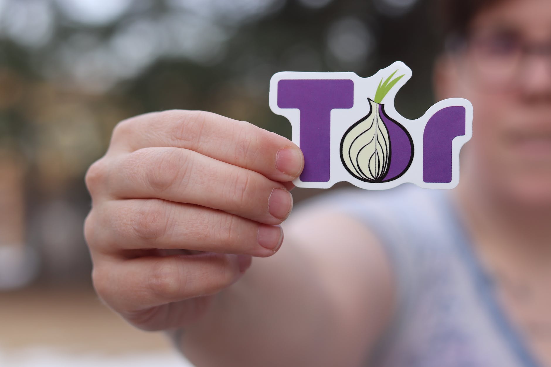 person holding logo of the onion router