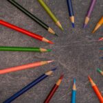 multicolored pencils arranged on shabby table