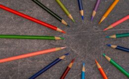 multicolored pencils arranged on shabby table