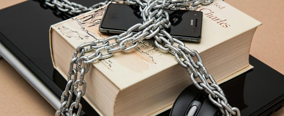 black android smartphone on top of white book