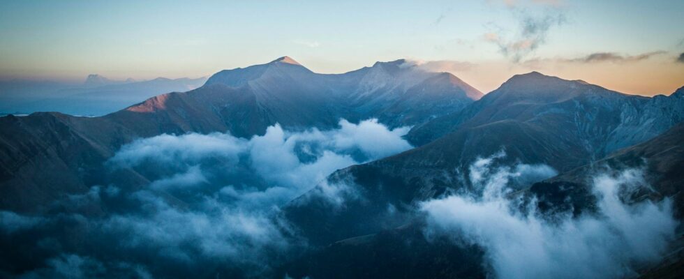 photography of mountain with blue sky as backgroundw